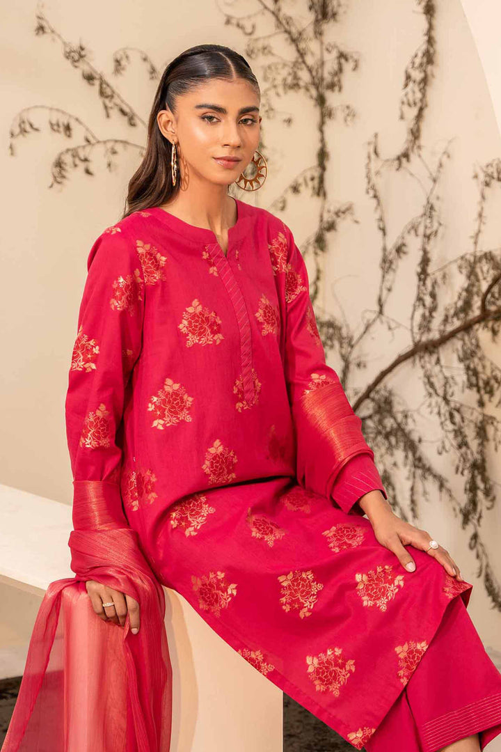 A model wearing a jacquard pink shirt with maysuri dupatta & cambric trousers with intricate gold embroidery.