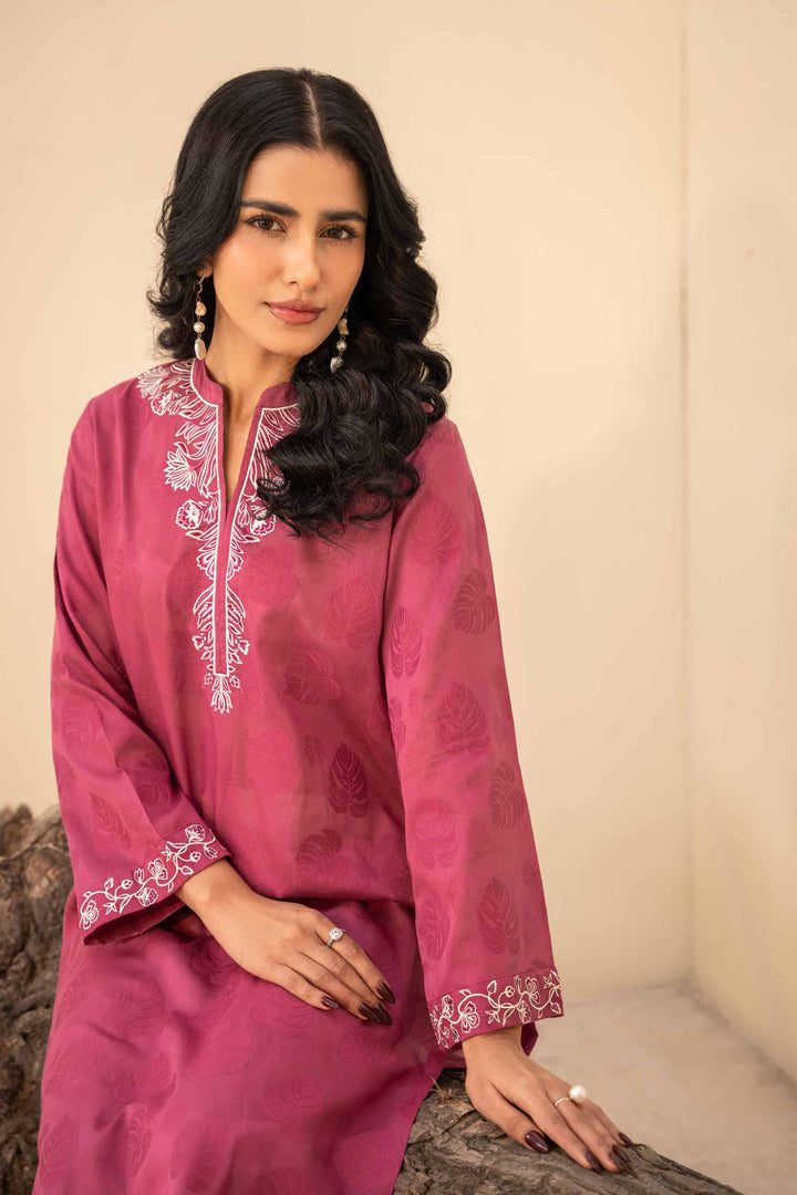 A pink kurta suit, showcasing traditional attire with elegance and grace.
